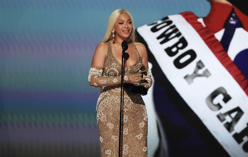 Beyonce takes the stage to collect the Grammy for album of the year. 